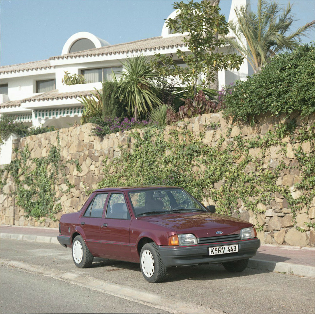 This archival image documents the 1985 Ford Orion Mark I 1.6 LHD on scenic road with ivy-covered wall and is preserved in the Ford Heritage Vault as part of Ford Motor Company's historic photographic archive. Free for personal, non-commercial use....