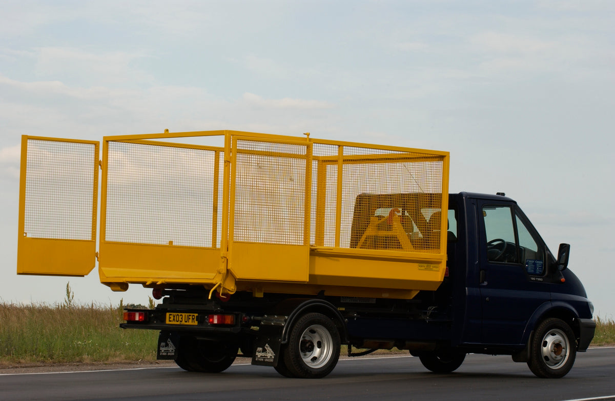 This archival image documents the 2003 Ford Transit Mark IV conversion with wire container rear view on scenic road and is preserved in the Ford Heritage Vault as part of Ford Motor Company's historic photographic archive. Free for personal, non-c...