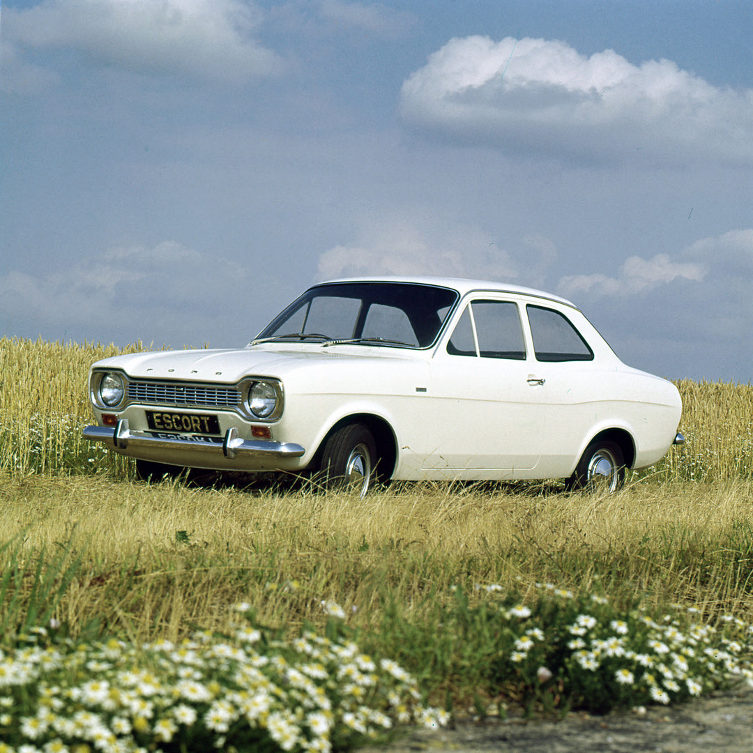 This archival image documents the 1967 Ford Escort Mark I Super and Deluxe in scenic field with flowers and is preserved in the Ford Heritage Vault as part of Ford Motor Company's historic photographic archive. Free for personal, non-commercial us...