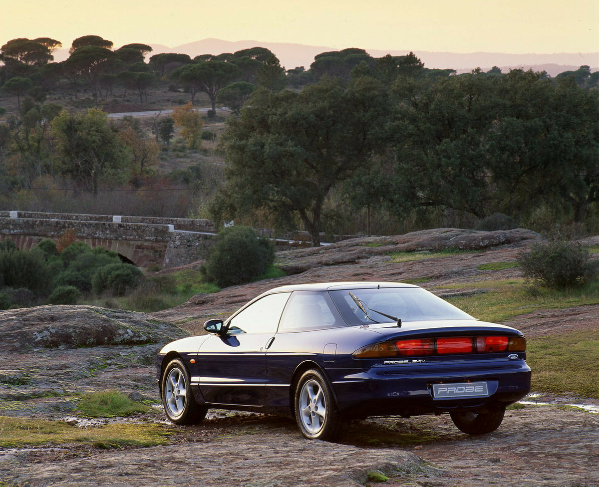 This archival image documents the 1993 Ford Probe 24v Mark II with trees and is preserved in the Ford Heritage Vault as part of Ford Motor Company's historic photographic archive. Free for personal, non-commercial use. Ford Heritage Vault referenc...
