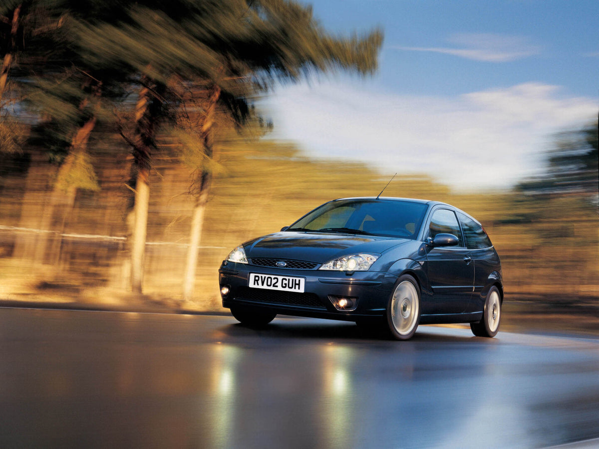 This archival image documents the 2002 Ford Focus Mark I action shot on scenic road with trees and is preserved in the Ford Heritage Vault as part of Ford Motor Company's historic photographic archive. Free for personal, non-commercial use. Ford H...