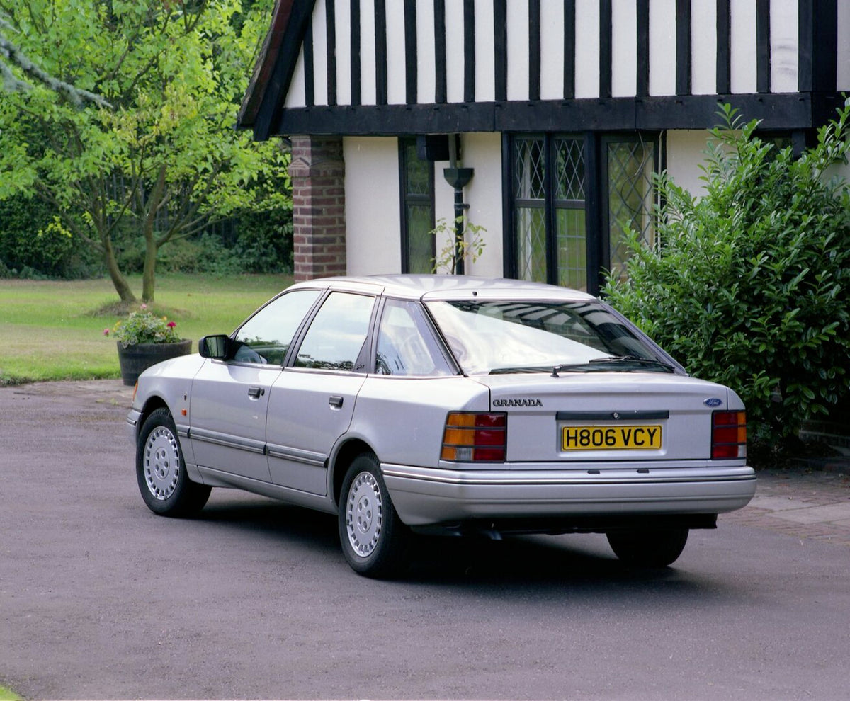 This archival image documents the 1990 Ford Granada MK III Ghia X rear view in front of scenic house and is preserved in the Ford Heritage Vault as part of Ford Motor Company's historic photographic archive. Free for personal, non-commercial use. ...