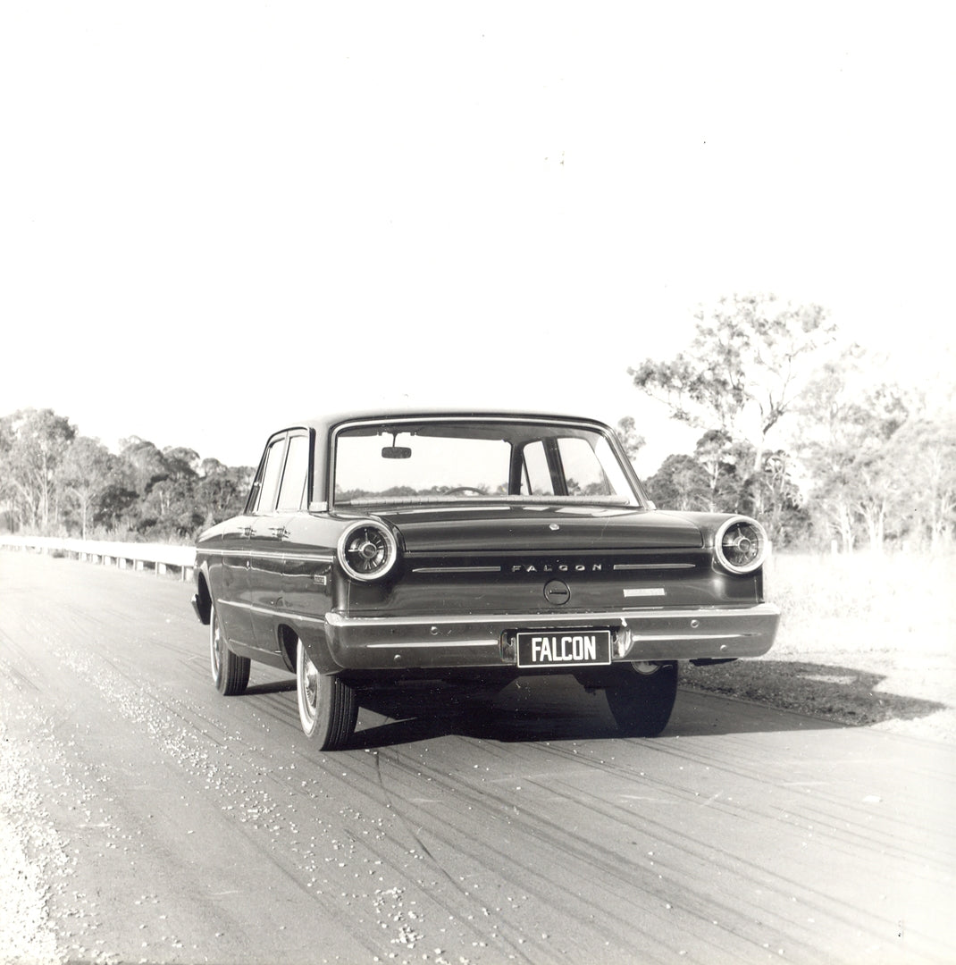 This archival image documents the 1965 Ford XP Falcon rear view on scenic road with trees and is preserved in the Ford Heritage Vault as part of Ford Motor Company's historic photographic archive. Free for personal, non-commercial use. Ford Herita...
