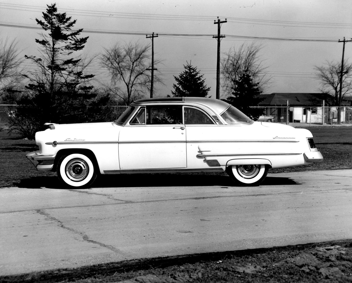 This archival image documents the 1954 Monarch Sun Valley Coupe side view on scenic road with trees AR-2007-5 and is preserved in the Ford Heritage Vault as part of Ford Motor Company's historic photographic archive. Free for personal, non-commerc...