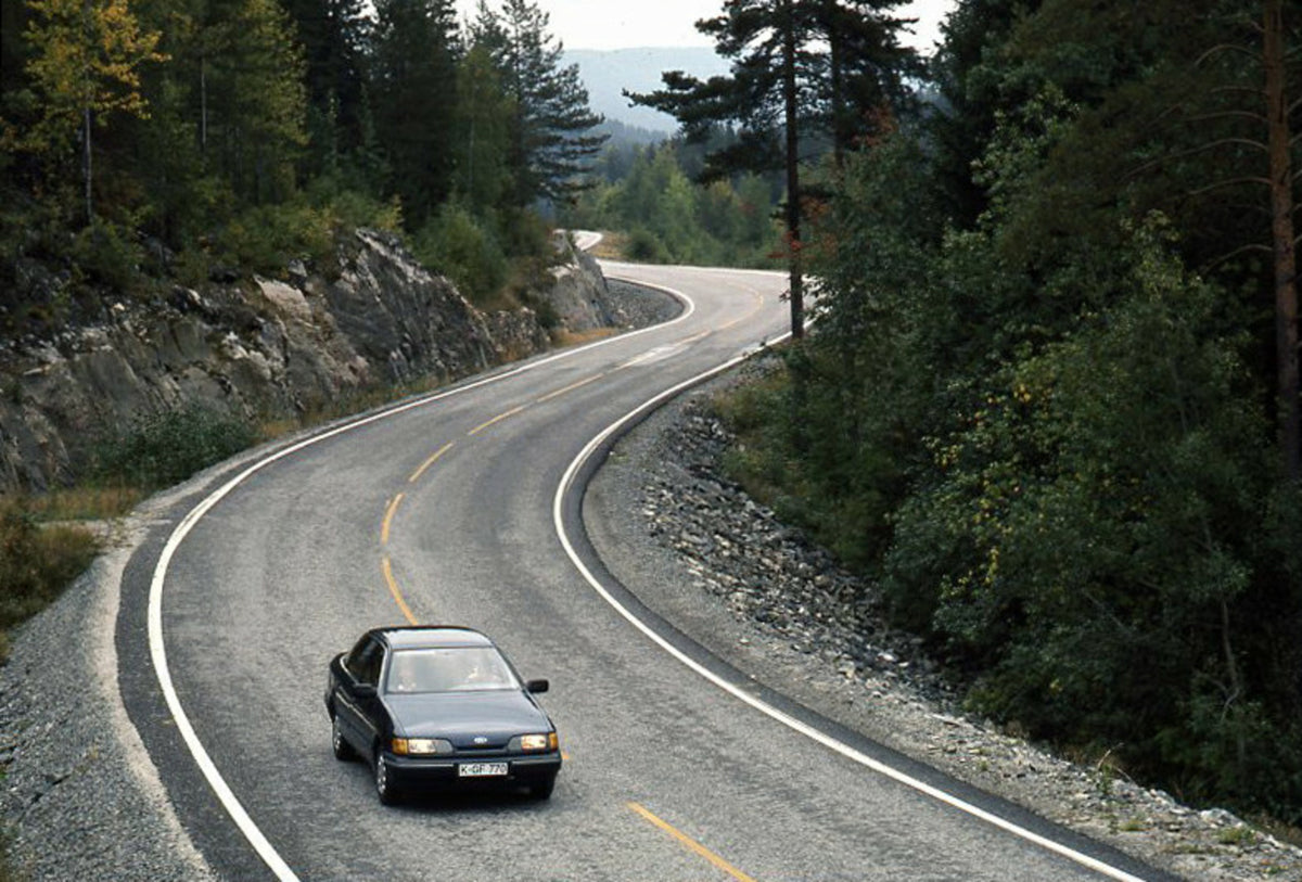 This archival image documents the 1985 Ford Scorpio Mark I GL aerial view on scenic road with trees and is preserved in the Ford Heritage Vault as part of Ford Motor Company's historic photographic archive. Free for personal, non-commercial use. F...