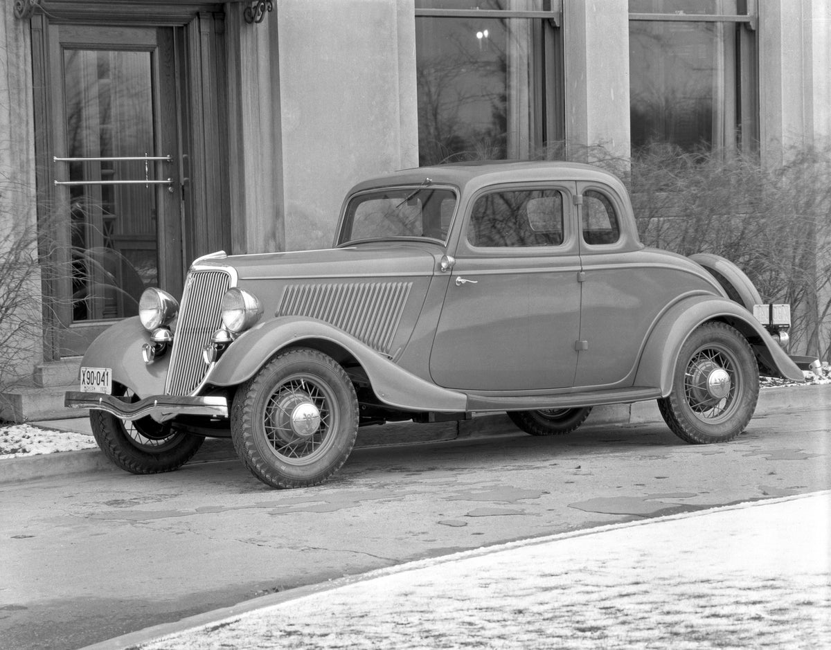 This archival image documents the 1934 Ford DeLuxe Coupe and is preserved in the Ford Heritage Vault as part of Ford Motor Company's historic photographic archive. Free for personal, non-commercial use. Ford Heritage Vault reference AR-2008-8.1.6.86.
