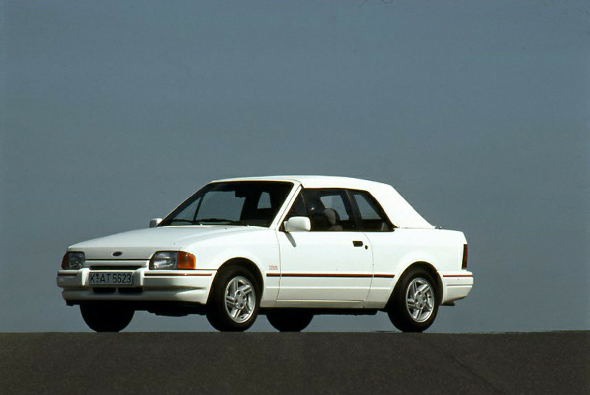 This archival image documents the 1989 Ford Escort Mark IV Cabriolet LHD with scenic blue sky and is preserved in the Ford Heritage Vault as part of Ford Motor Company's historic photographic archive. Free for personal, non-commercial use. Ford He...