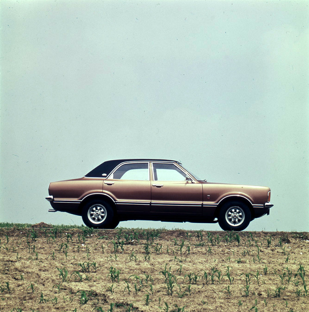 This archival image documents the 1974 Ford Taunus GXL side view on scenic hill and is preserved in the Ford Heritage Vault as part of Ford Motor Company's historic photographic archive. Free for personal, non-commercial use. Ford Heritage Vault r...