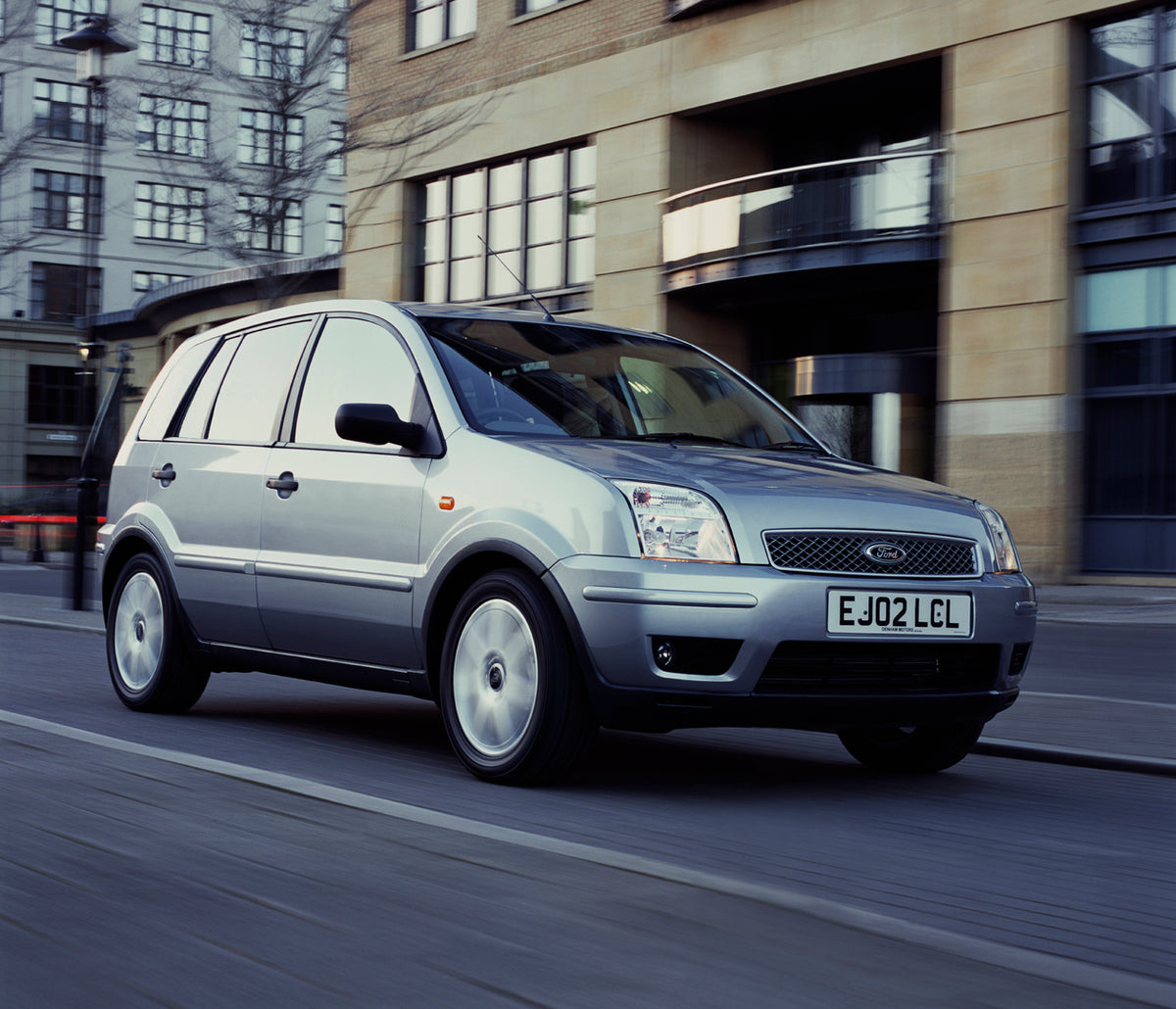 This archival image documents the 2003 Ford Fusion Plus action shot on city street and is preserved in the Ford Heritage Vault as part of Ford Motor Company's historic photographic archive. Free for personal, non-commercial use. Ford Heritage Vaul...