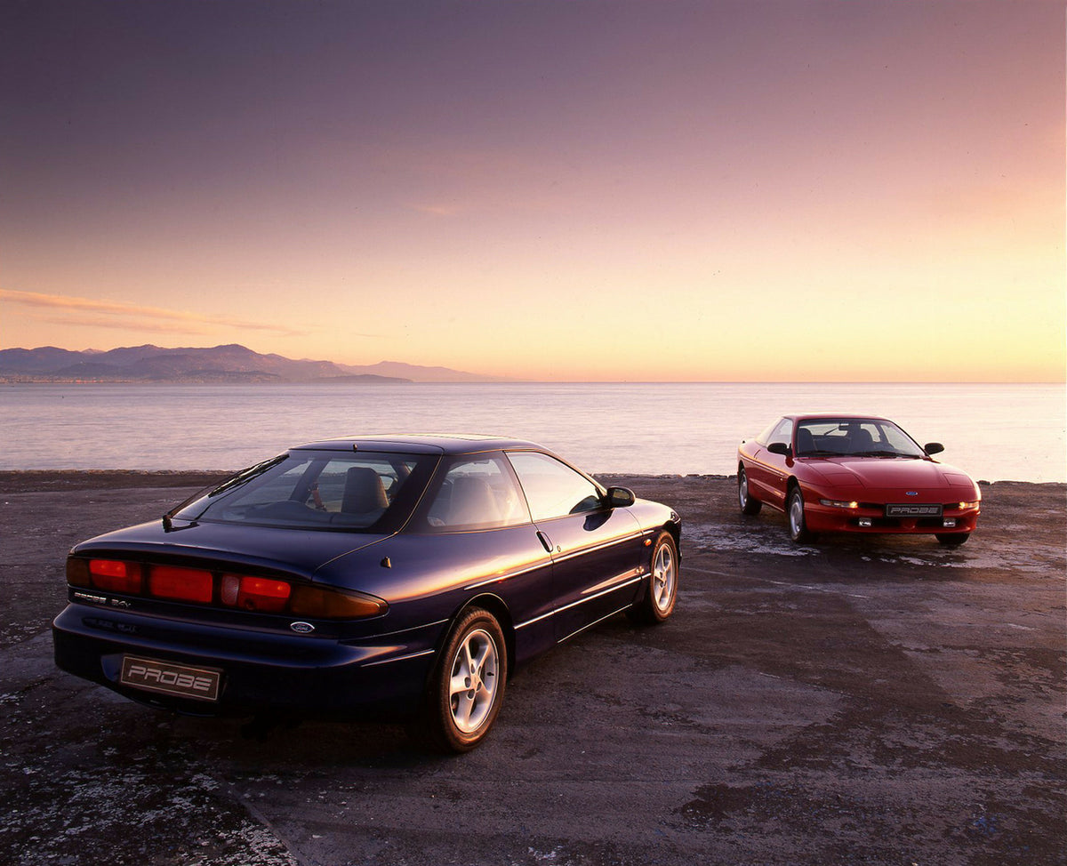 This archival image documents the 1993 Ford Probe 24v and Probe 16v Mark II parked by water and is preserved in the Ford Heritage Vault as part of Ford Motor Company's historic photographic archive. Free for personal, non-commercial use. Ford Heri...