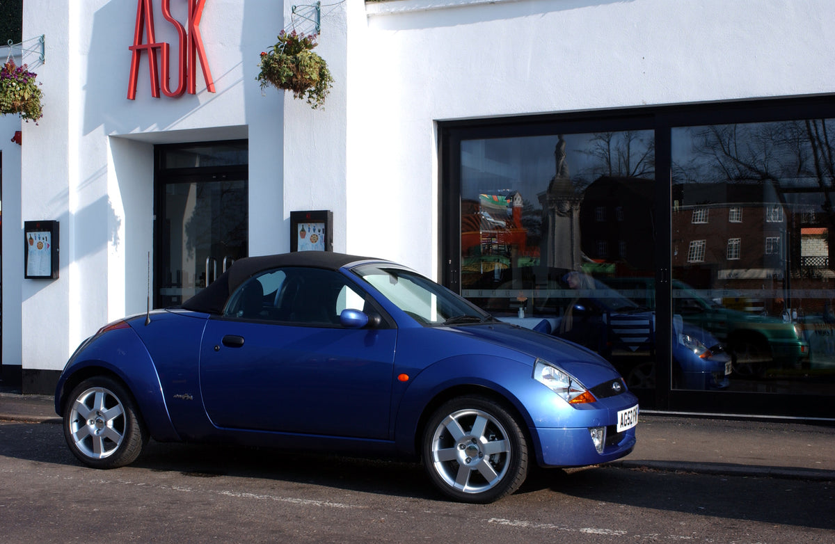 This archival image documents the 2003 Ford Street Ka Mark I side view on scenic city street and is preserved in the Ford Heritage Vault as part of Ford Motor Company's historic photographic archive. Free for personal, non-commercial use. Ford Her...