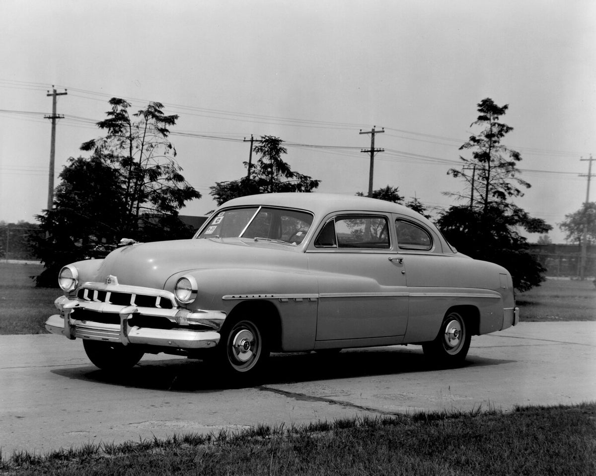 This archival image documents the 1951 Monarch Coupe on scenic road with trees AR-2007-5 and is preserved in the Ford Heritage Vault as part of Ford Motor Company's historic photographic archive. Free for personal, non-commercial use. Ford Heritag...