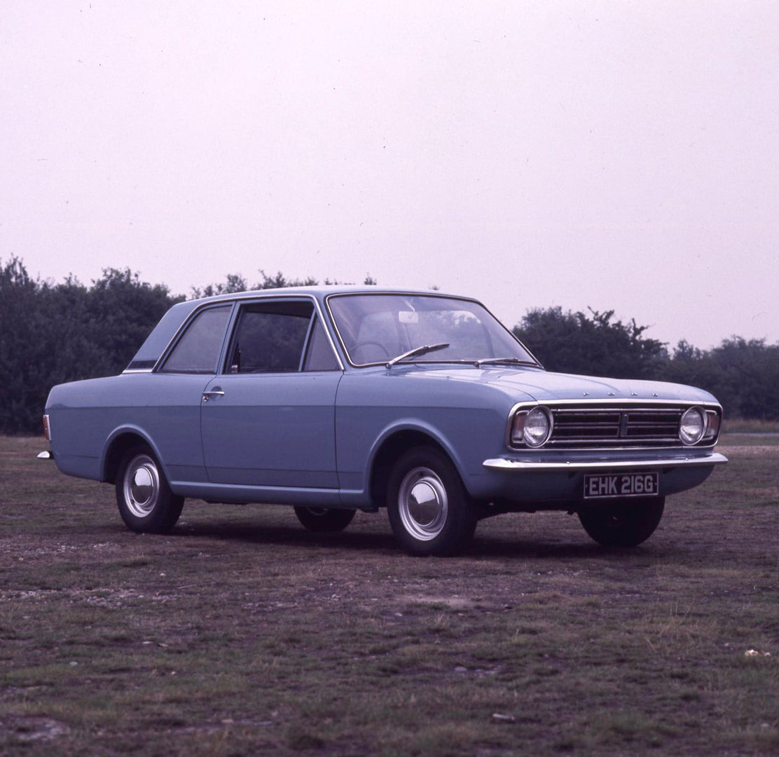 This archival image documents the 1969 Ford Cortina MK II DL 1300 2 door in scenic field with trees and is preserved in the Ford Heritage Vault as part of Ford Motor Company's historic photographic archive. Free for personal, non-commercial use. F...