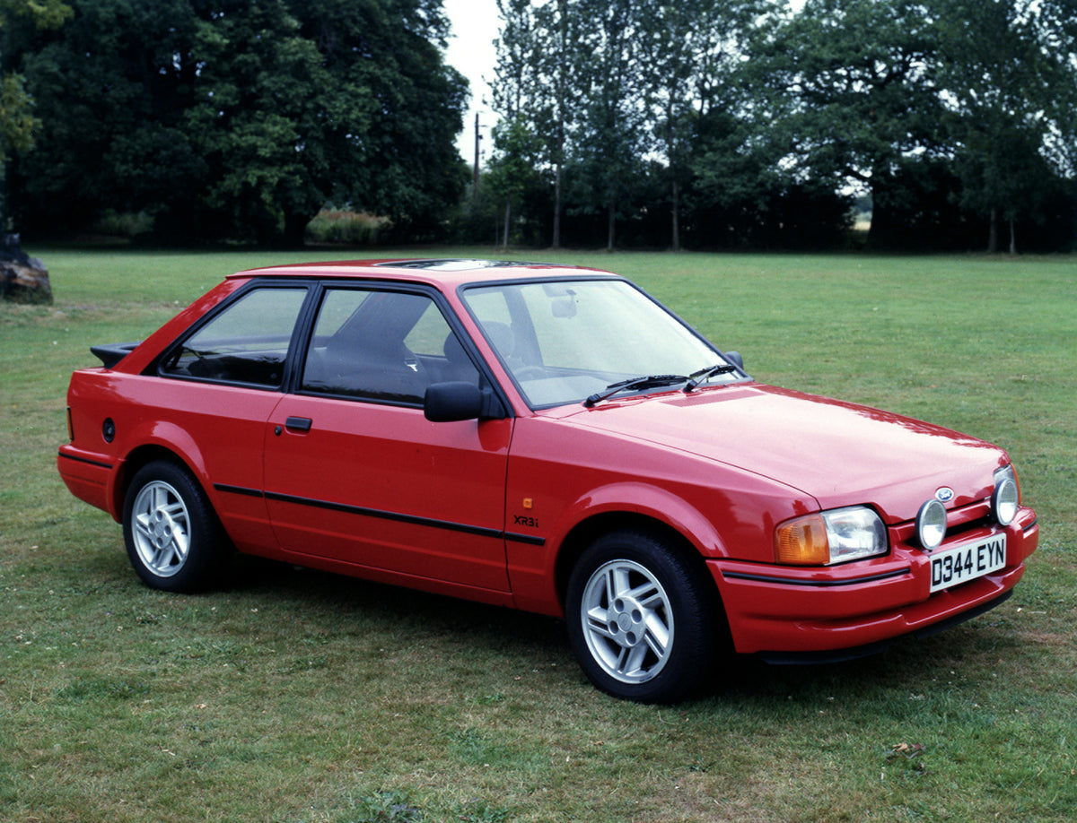 This archival image documents the 1986 Ford Escort Mark IV XR3i in scenic field and is preserved in the Ford Heritage Vault as part of Ford Motor Company's historic photographic archive. Free for personal, non-commercial use. Ford Heritage Vault r...