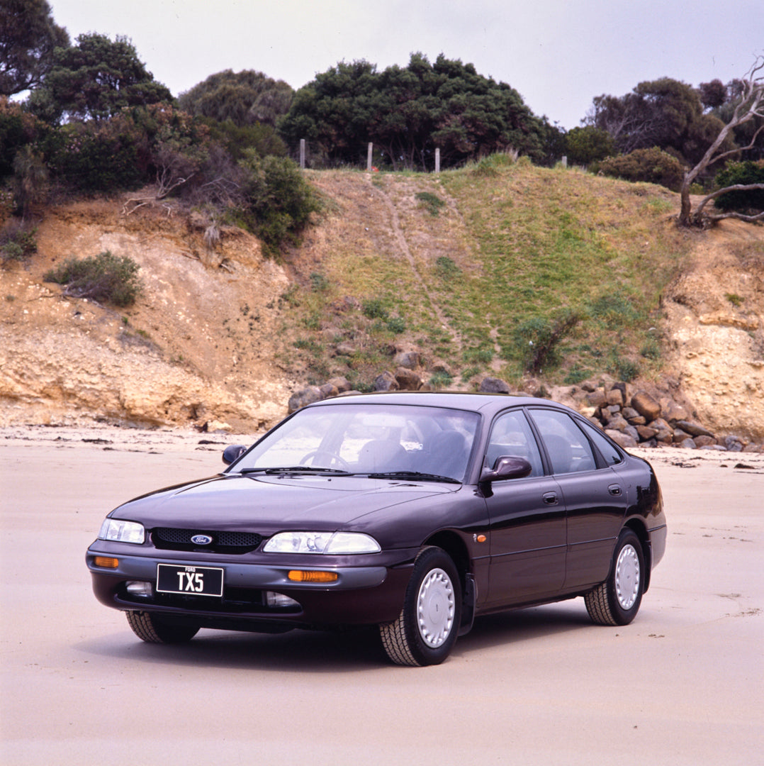 This archival image documents the 1995 Ford AY Telstar TX5 Sedan Passenger Side Front End View on the Beach FAP-2011-3 and is preserved in the Ford Heritage Vault as part of Ford Motor Company's historic photographic archive. Free for personal, no...