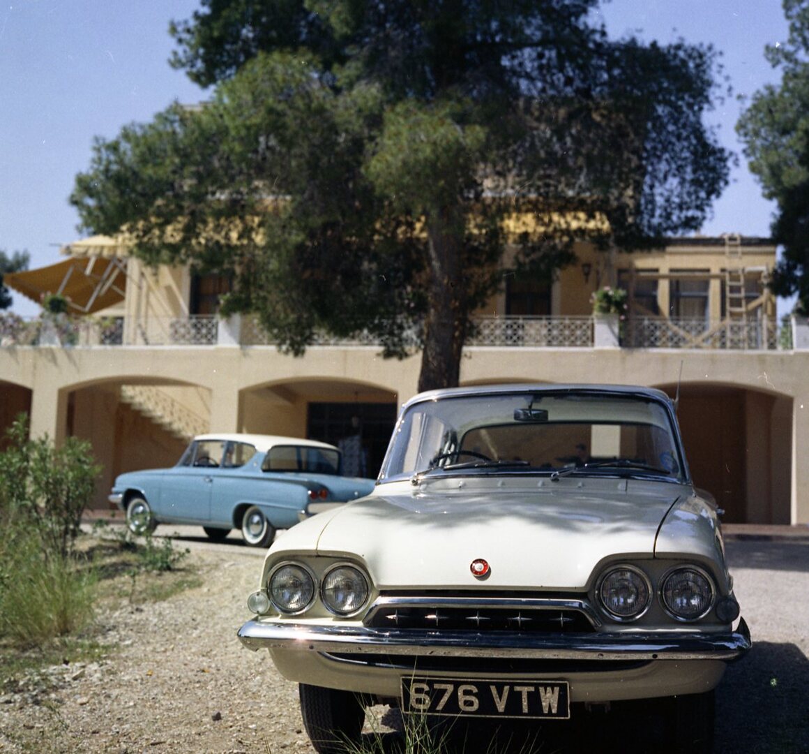 This archival image documents the 1961 Ford Classic and Consul 315s front and rear view in front of scenic building in Greece and is preserved in the Ford Heritage Vault as part of Ford Motor Company's historic photographic archive. Free for perso...