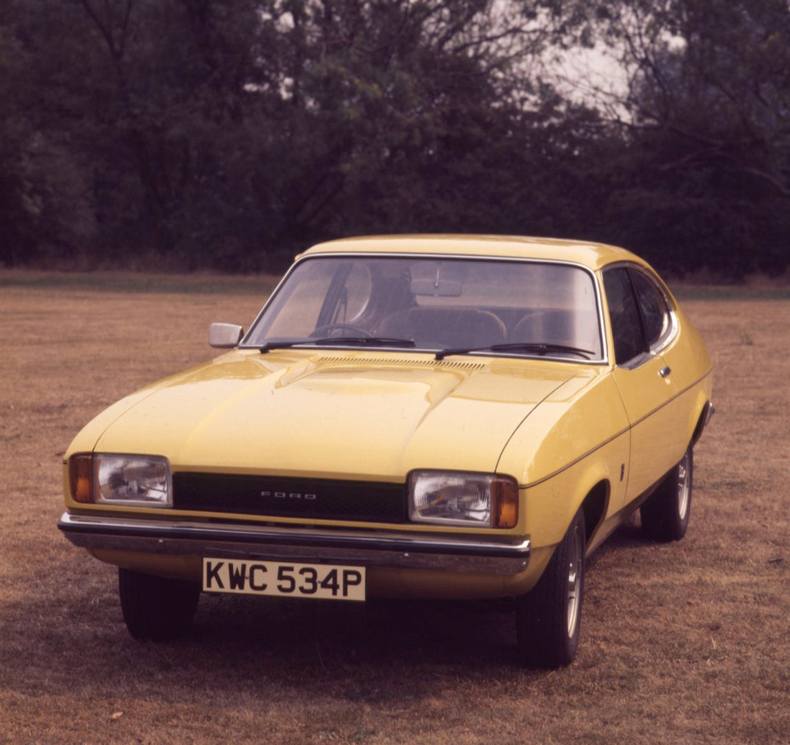 This archival image documents the 1975 Ford Capri MK II 1.3 L in scenic field and is preserved in the Ford Heritage Vault as part of Ford Motor Company's historic photographic archive. Free for personal, non-commercial use. Ford Heritage Vault ref...