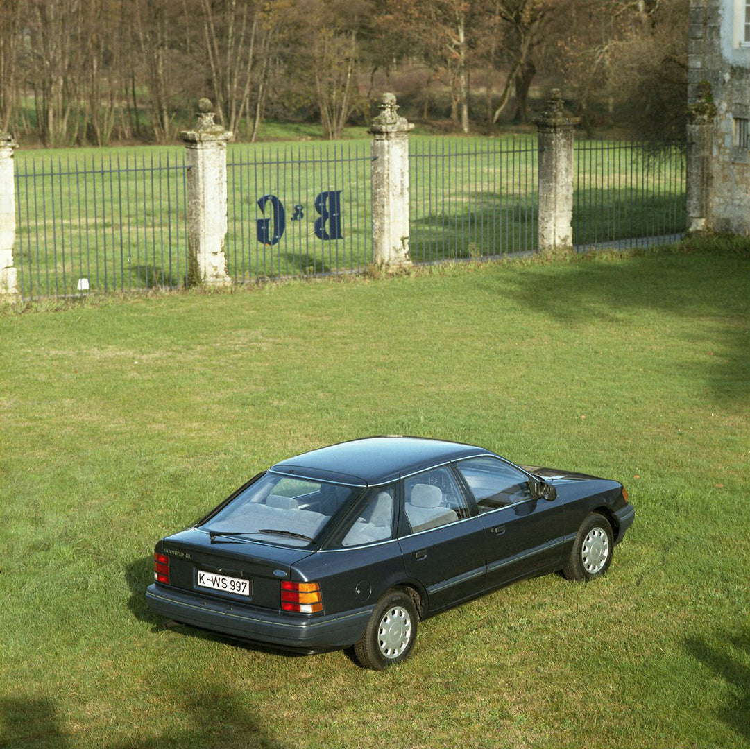 This archival image documents the 1984 Ford Scorpio Mark I LHD rear view with scenic fence in Bordeaux and is preserved in the Ford Heritage Vault as part of Ford Motor Company's historic photographic archive. Free for personal, non-commercial use...