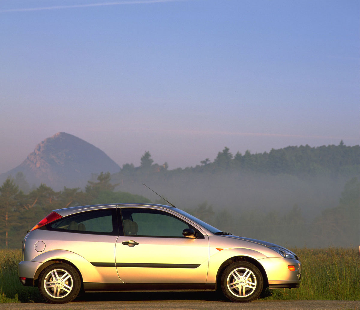 This archival image documents the 1998 Ford Focus side view with scenic mountains and is preserved in the Ford Heritage Vault as part of Ford Motor Company's historic photographic archive. Free for personal, non-commercial use. Ford Heritage Vault...