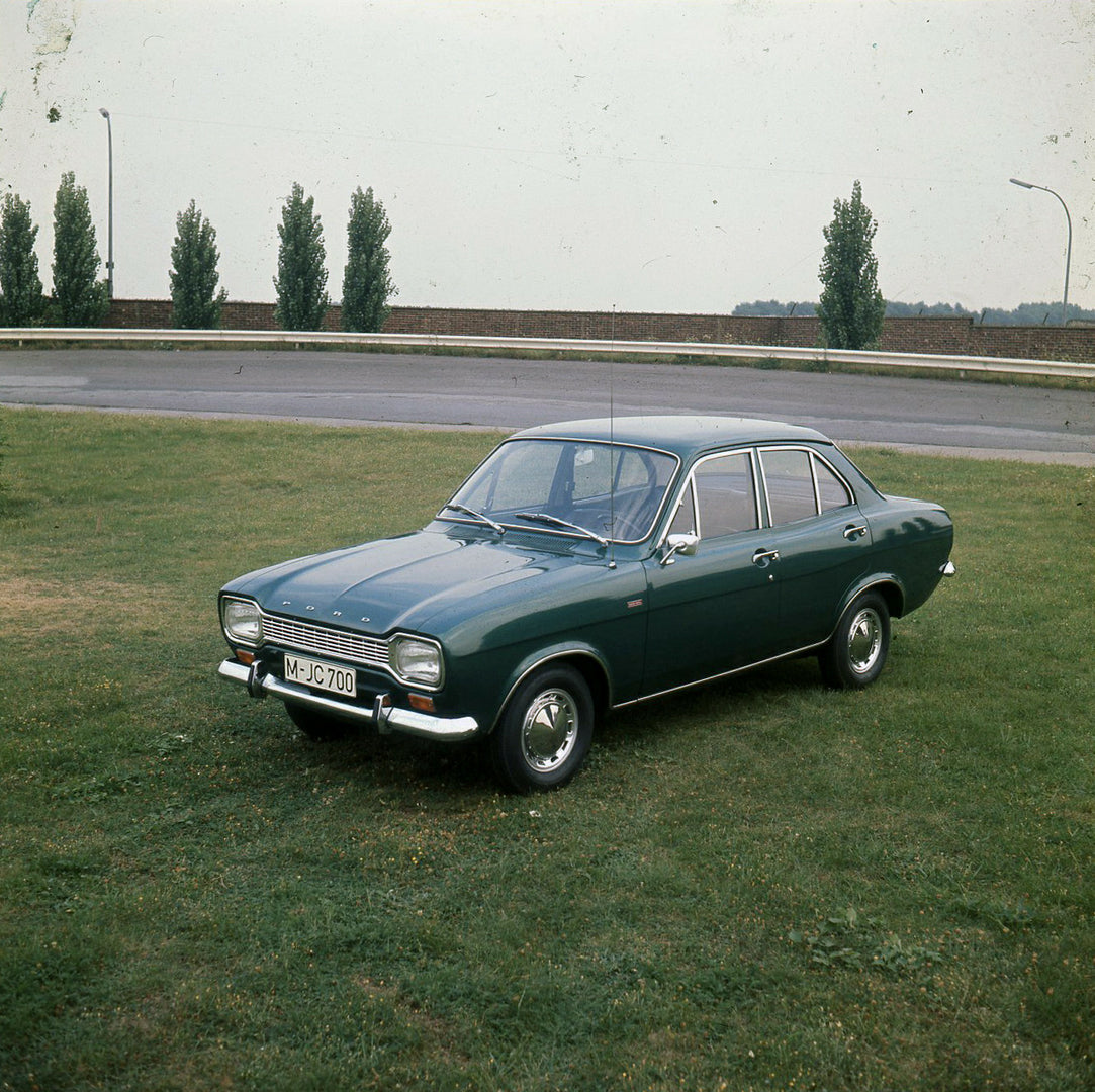 This archival image documents the 1973 Ford Escort Mark I in scenic field and is preserved in the Ford Heritage Vault as part of Ford Motor Company's historic photographic archive. Free for personal, non-commercial use. Ford Heritage Vault referen...