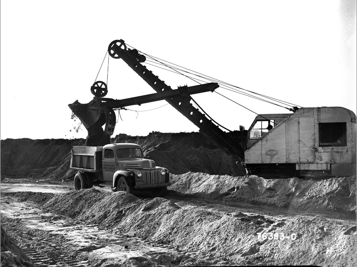 This archival image documents the 1942 Ford dump truck at construction site and is preserved in the Ford Heritage Vault as part of Ford Motor Company's historic photographic archive. Free for personal, non-commercial use. Ford Heritage Vault refer...