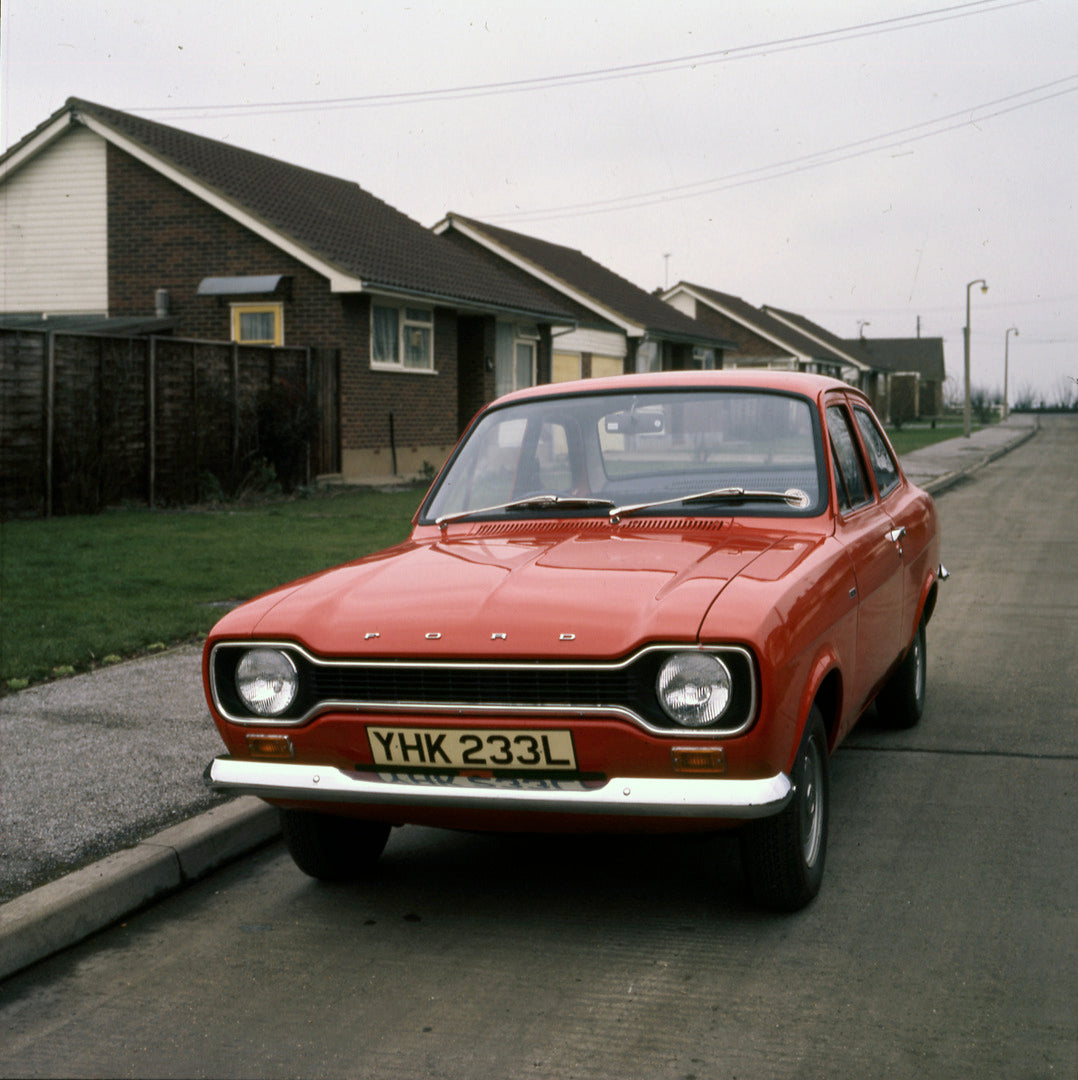 This archival image documents the 1974 Ford Escort Mark II 1100 front view on neighborhood street 1973-203 and is preserved in the Ford Heritage Vault as part of Ford Motor Company's historic photographic archive. Free for personal, non-commercial...