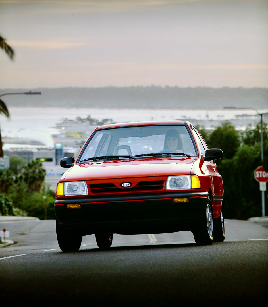 This archival image documents the 1990 Ford Escort two-door and is preserved in the Ford Heritage Vault as part of Ford Motor Company's historic photographic archive. Free for personal, non-commercial use. Ford Heritage Vault reference AR-2001-94-...