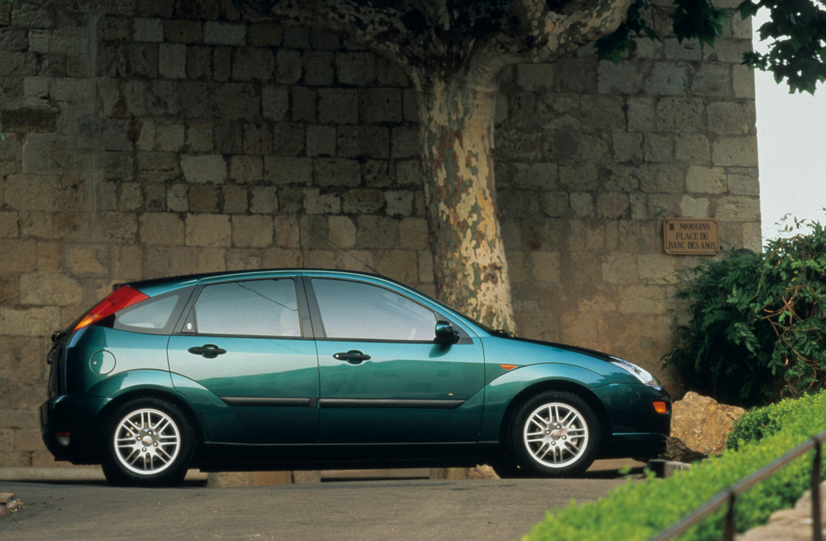 This archival image documents the 1998 Ford Focus side view in front of scenic wall and is preserved in the Ford Heritage Vault as part of Ford Motor Company's historic photographic archive. Free for personal, non-commercial use. Ford Heritage Vau...