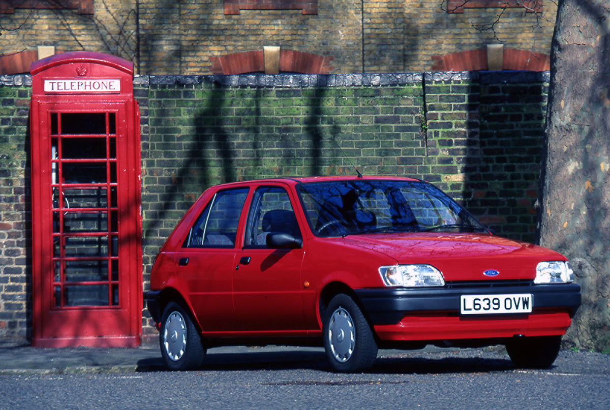This archival image documents the 1994 Ford Fiesta Mark III in front of brick building with telephone booth and is preserved in the Ford Heritage Vault as part of Ford Motor Company's historic photographic archive. Free for personal, non-commercia...