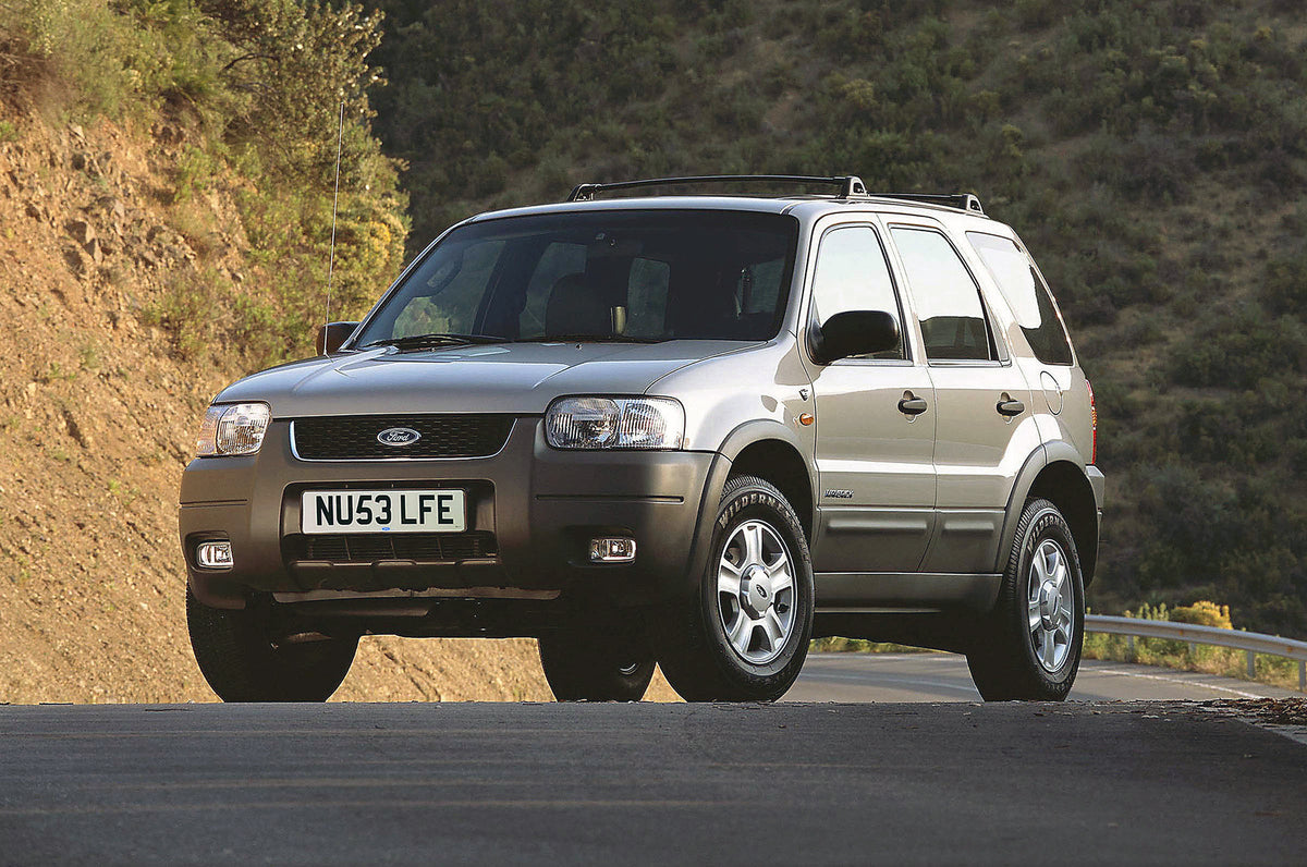 This archival image documents the 2003 Ford Maverick on scenic road and is preserved in the Ford Heritage Vault as part of Ford Motor Company's historic photographic archive. Free for personal, non-commercial use. Ford Heritage Vault reference AR-...