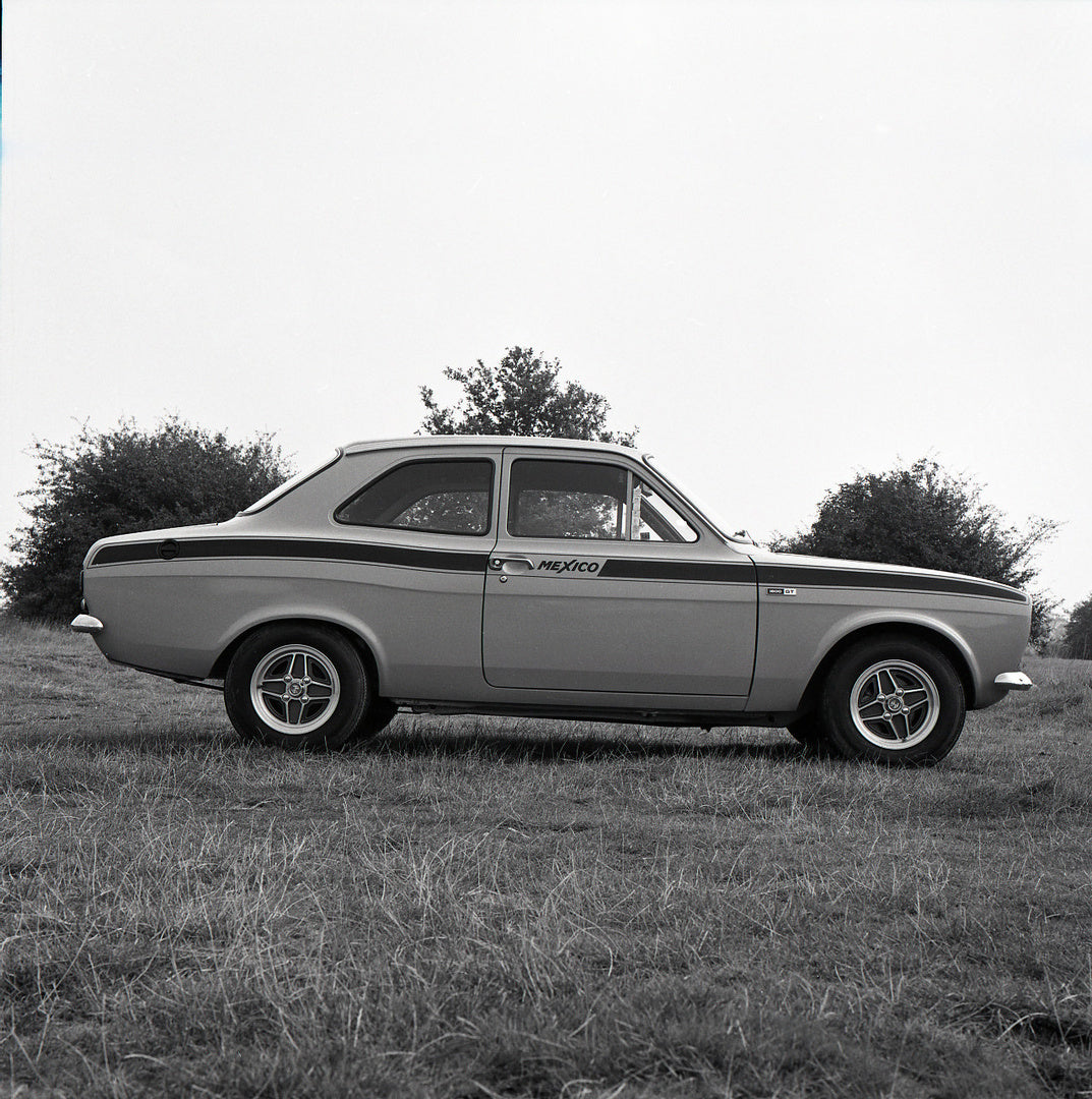 This archival image documents the 1973 Ford Escort Mexico MK1 1600 GT 2 Door side view in scenic field with trees and is preserved in the Ford Heritage Vault as part of Ford Motor Company's historic photographic archive. Free for personal, non-com...