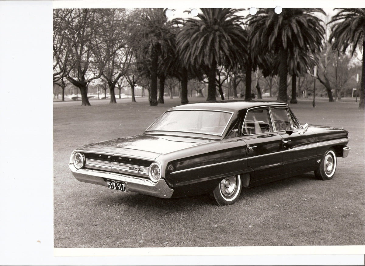 This archival image documents the 1964 Ford Galaxie 500 rear view with scenic palm trees and is preserved in the Ford Heritage Vault as part of Ford Motor Company's historic photographic archive. Free for personal, non-commercial use. Ford Heritag...