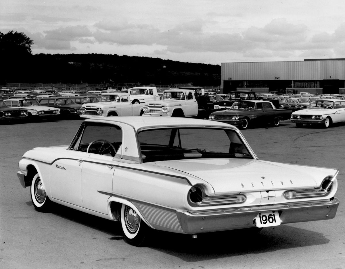 This archival image documents the 1961 Meteor Montcalm Sedan rear view in parking lot with other Ford and Mercury vehicles AR-2007-5 and is preserved in the Ford Heritage Vault as part of Ford Motor Company's historic photographic archive. Free fo...