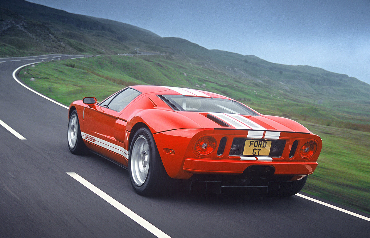 This archival image documents the 2003 Ford GT rear view action shot on scenic road and is preserved in the Ford Heritage Vault as part of Ford Motor Company's historic photographic archive. Free for personal, non-commercial use. Ford Heritage Vau...