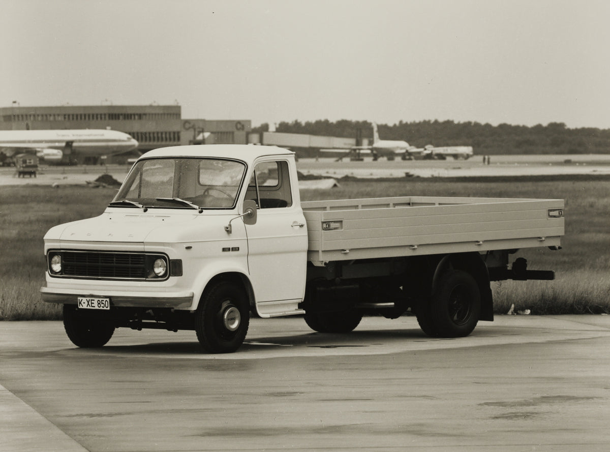 This archival image documents the 1970 Ford A-Series Truck with planes in background and is preserved in the Ford Heritage Vault as part of Ford Motor Company's historic photographic archive. Free for personal, non-commercial use. Ford Heritage Va...