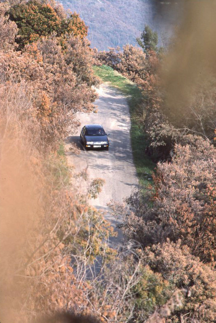 This archival image documents the 1985 Ford Sierra 2.0 IS LHD aerial view on scenic road with trees and is preserved in the Ford Heritage Vault as part of Ford Motor Company's historic photographic archive. Free for personal, non-commercial use. F...