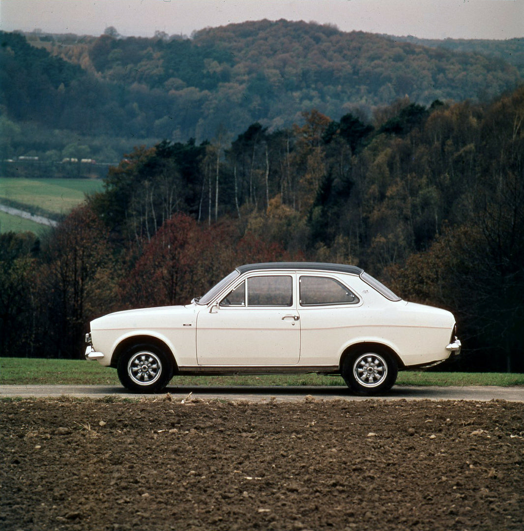 This archival image documents the 1974 Ford Escort Mark I GXL side view on scenic road with trees and is preserved in the Ford Heritage Vault as part of Ford Motor Company's historic photographic archive. Free for personal, non-commercial use. For...