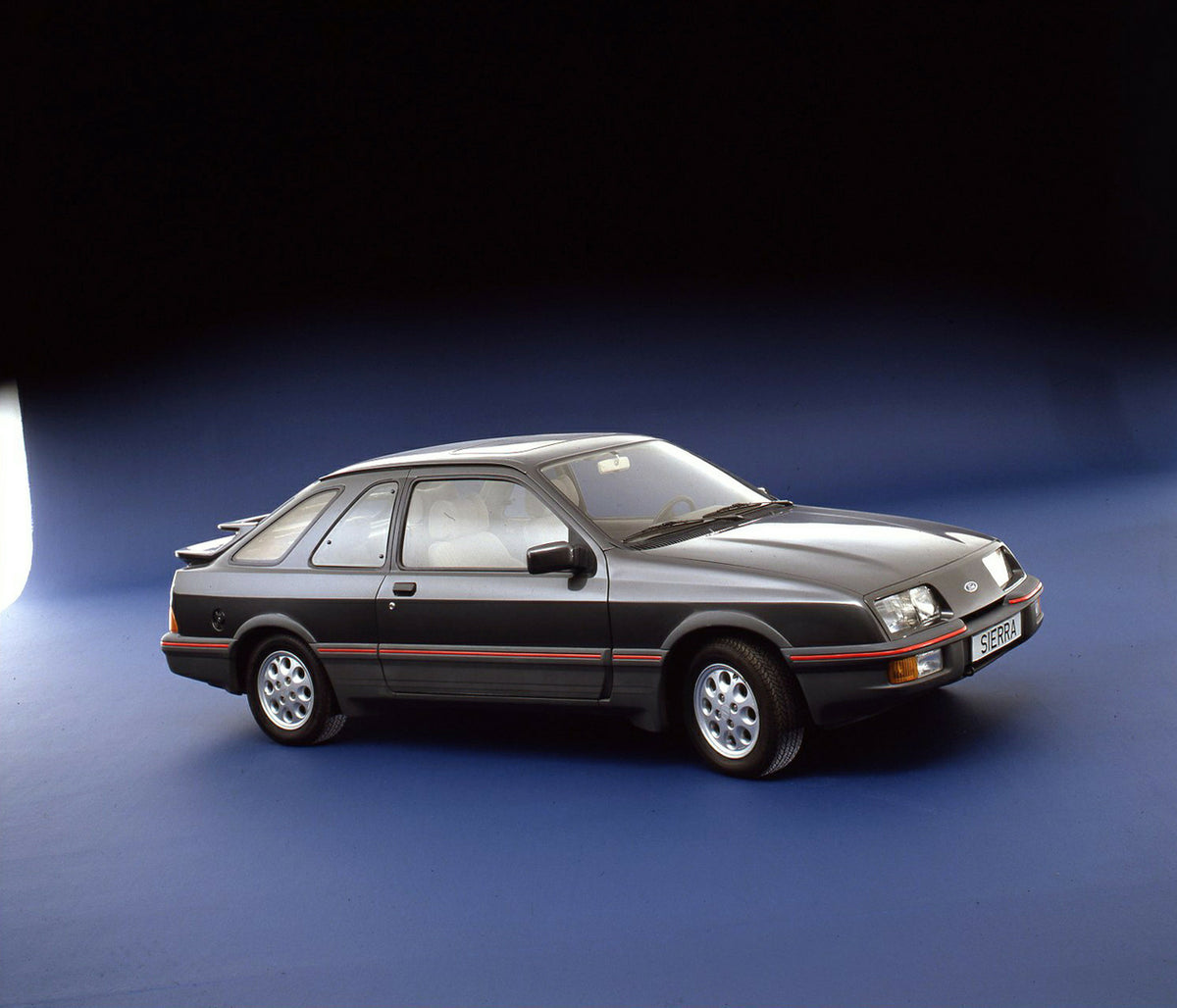 This archival image documents the 1983 Ford Sierra XR4 Mark I LHD in studio and is preserved in the Ford Heritage Vault as part of Ford Motor Company's historic photographic archive. Free for personal, non-commercial use. Ford Heritage Vault refer...