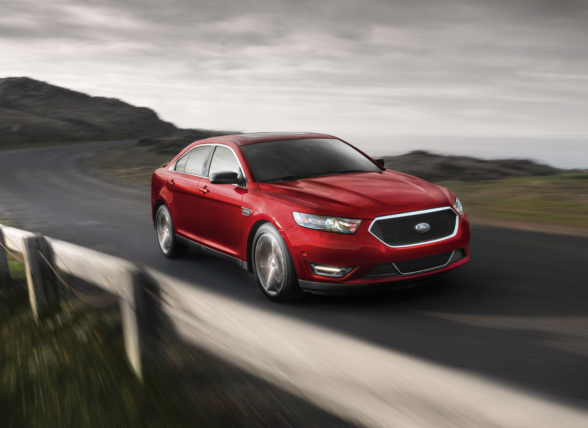 This archival image documents the 2015 Ford Taurus SHO action shot on scenic road and is preserved in the Ford Heritage Vault as part of Ford Motor Company's historic photographic archive. Free for personal, non-commercial use. Ford Heritage Vault...