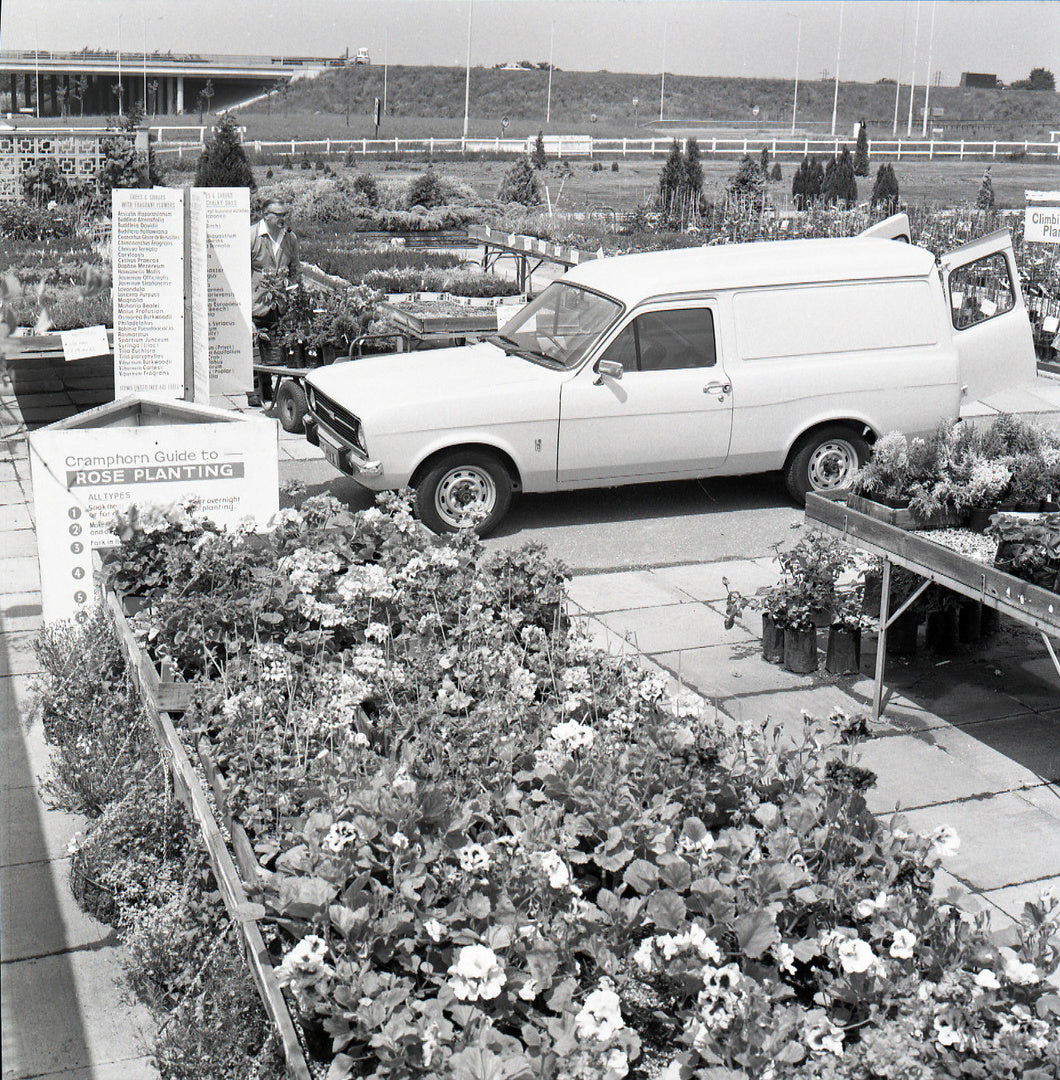 This archival image documents the 1975 Ford Escort Van Mark II side view at garden store and is preserved in the Ford Heritage Vault as part of Ford Motor Company's historic photographic archive. Free for personal, non-commercial use. Ford Heritag...