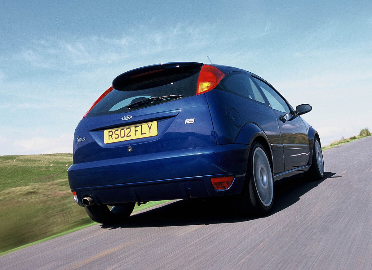 This archival image documents the 2002 Ford Focus RS Mark I rear view action shot on scenic road and is preserved in the Ford Heritage Vault as part of Ford Motor Company's historic photographic archive. Free for personal, non-commercial use. Ford...