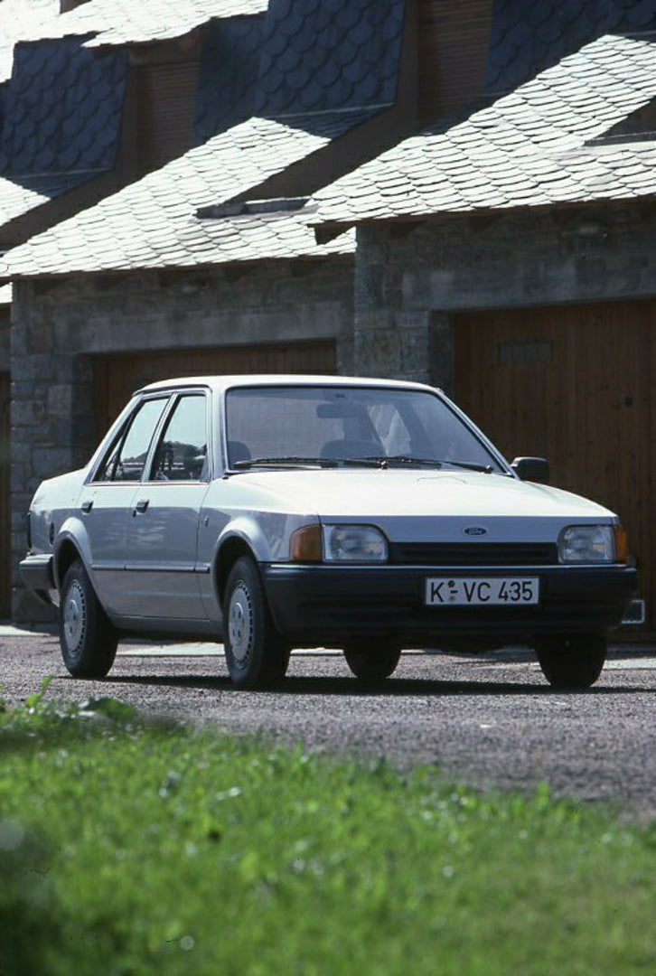 This archival image documents the 1986 Ford Orion Mark II in front of scenic garage and is preserved in the Ford Heritage Vault as part of Ford Motor Company's historic photographic archive. Free for personal, non-commercial use. Ford Heritage Vau...