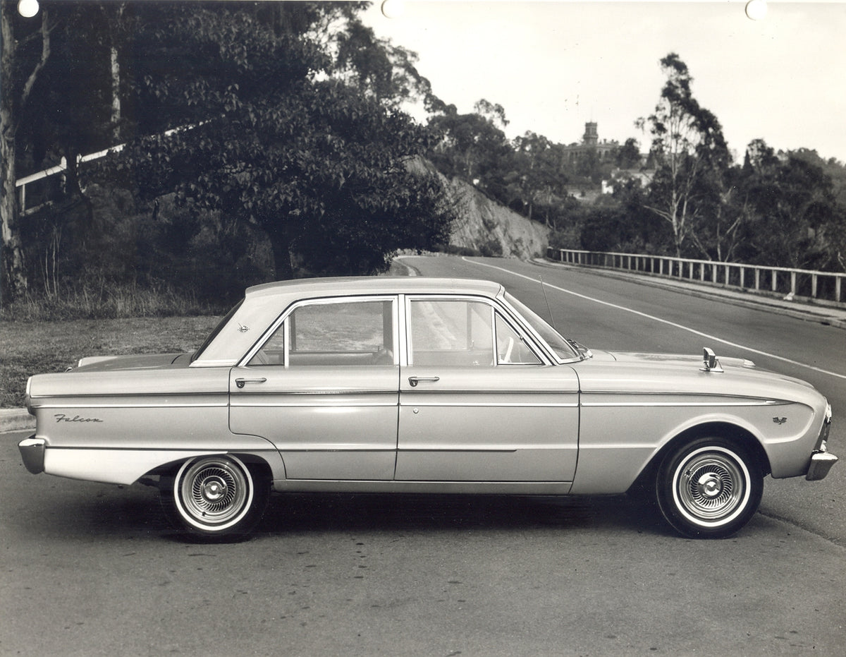This archival image documents the 1964 Ford XM Falcon side view on scenic road with trees and is preserved in the Ford Heritage Vault as part of Ford Motor Company's historic photographic archive. Free for personal, non-commercial use. Ford Herita...