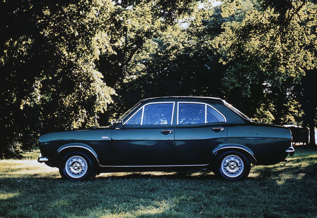 This archival image documents the 1970 Ford Escort Mark I 1300 XL Sport side view with scenic trees and is preserved in the Ford Heritage Vault as part of Ford Motor Company's historic photographic archive. Free for personal, non-commercial use. F...
