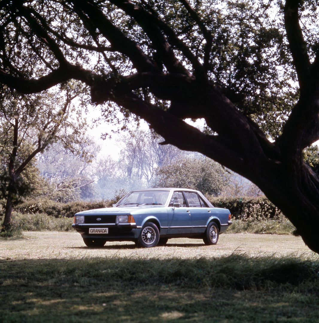 This archival image documents the 1977 Ford Granada GL under scenic trees and is preserved in the Ford Heritage Vault as part of Ford Motor Company's historic photographic archive. Free for personal, non-commercial use. Ford Heritage Vault referen...
