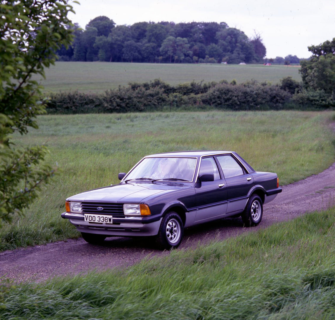 This archival image documents the 1981 Ford Cortina Carousel on scenic road with field and trees and is preserved in the Ford Heritage Vault as part of Ford Motor Company's historic photographic archive. Free for personal, non-commercial use. Ford...