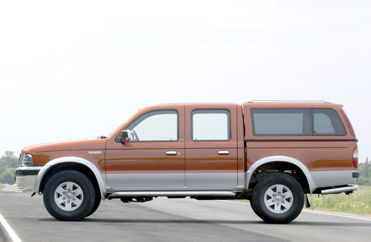 This archival image documents the 2003 Ford Ranger side view on scenic road and is preserved in the Ford Heritage Vault as part of Ford Motor Company's historic photographic archive. Free for personal, non-commercial use. Ford Heritage Vault refer...