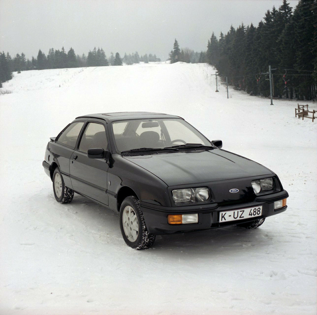 This archival image documents the 1985 Ford Sierra XR 4x4 LHD in snow with scenic trees and is preserved in the Ford Heritage Vault as part of Ford Motor Company's historic photographic archive. Free for personal, non-commercial use. Ford Heritage...