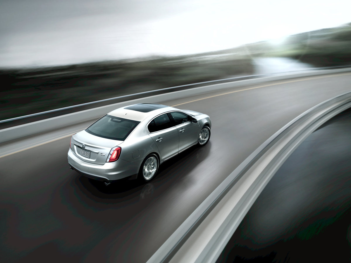 This archival image documents the 2010 Lincoln MKS action shot on road MS731378 and is preserved in the Ford Heritage Vault as part of Ford Motor Company's historic photographic archive. Free for personal, non-commercial use. Ford Heritage Vault r...