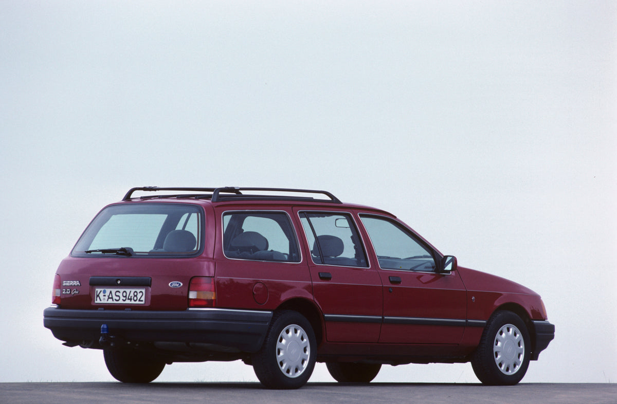 This archival image documents the 1987 Ford Seria 2.0 Ghia rear view with scenic blue sky and is preserved in the Ford Heritage Vault as part of Ford Motor Company's historic photographic archive. Free for personal, non-commercial use. Ford Herita...